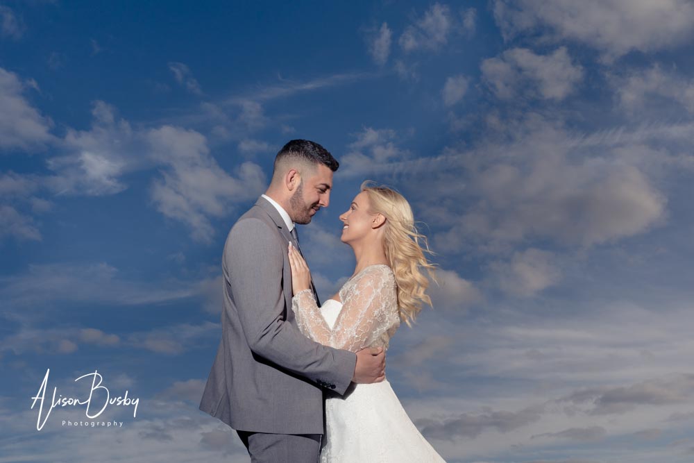 Planning a wedding. Bride and groom against a blue sky