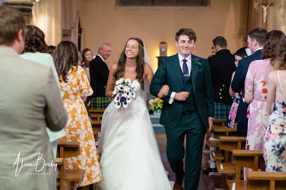 Bride and groom leaving wedding ceremony at our lady and st edmund in abingdon.