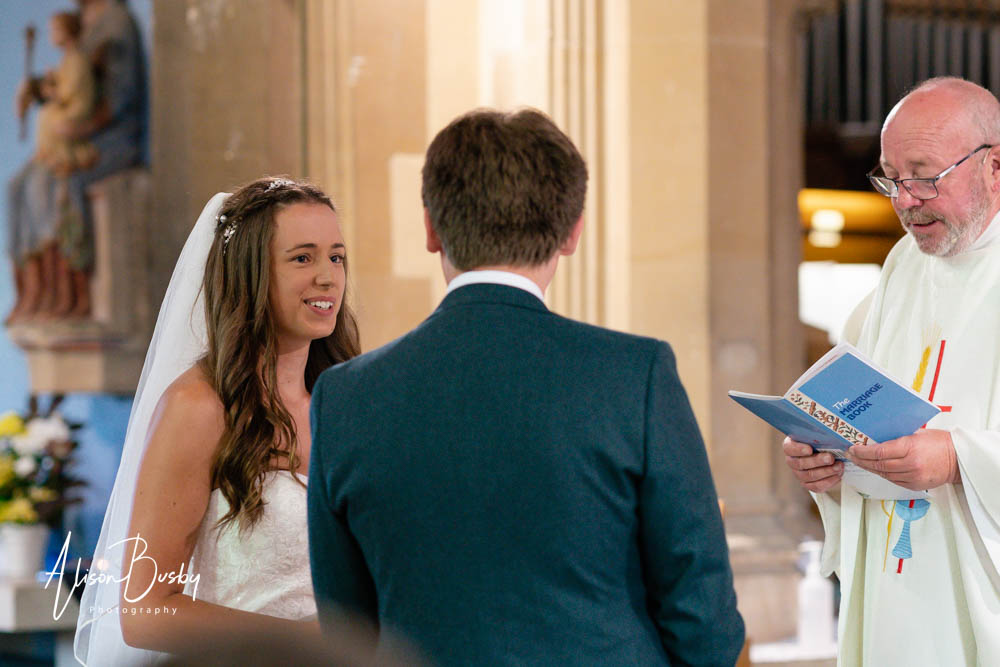 Bride and groom look at each other during wedding at our lady and st edmund in abingdon.