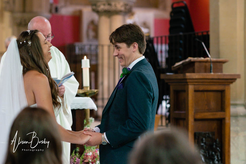 Bride and groom look at each other during wedding at our lady and st edmund in abingdon.