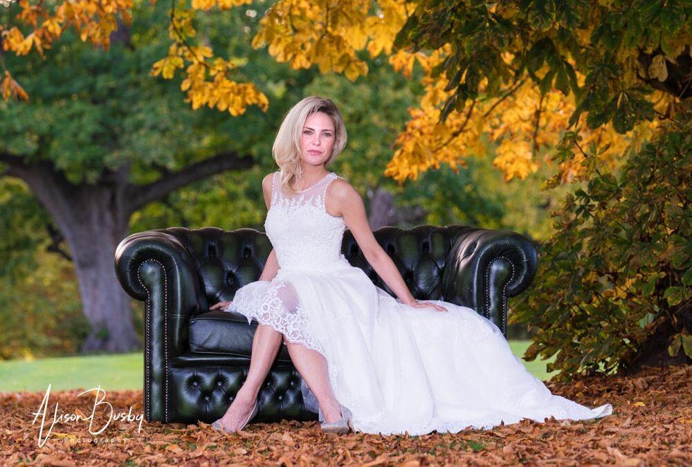 Autumn wedding. Bride seated under tree