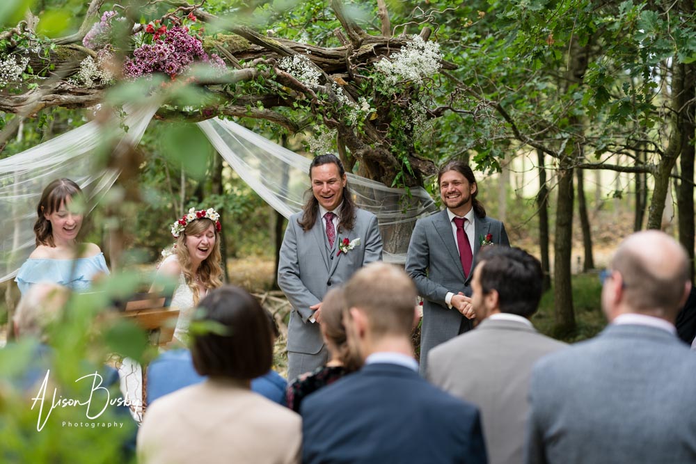 Buckinghamshire woodland wedding. Bride and groom under the tree arch at Endeavour Woodland Weddings.