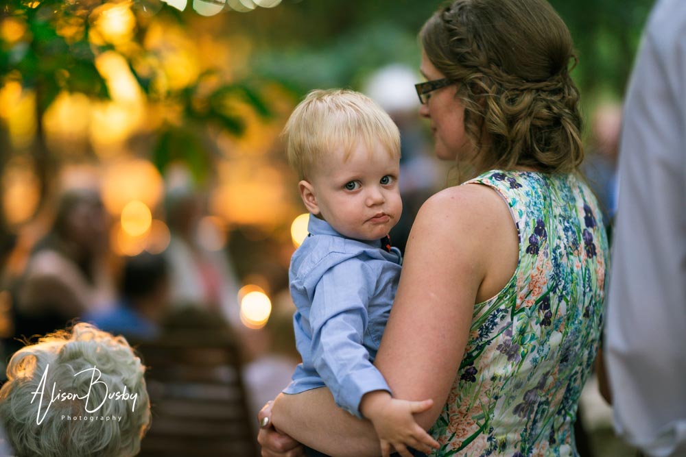 Buckinghamshire woodland wedding photographer. Wedding party around firepit at sunset. Endeavour Woodland Weddings.