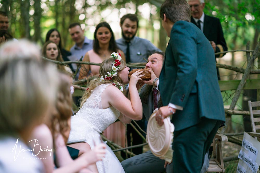 Buckinghamshire woodland wedding photographer. Wedding party around firepit at sunset. Endeavour Woodland Weddings.
