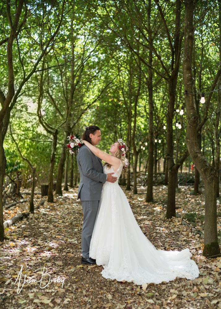 Buckinghamshire woodland wedding. Bride and groom under the tree canopy at Endeavour Woodland Weddings.