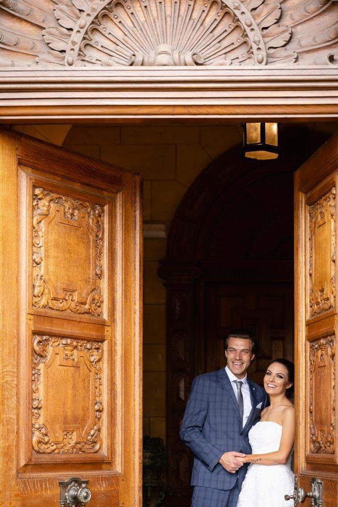 Oxfordshire wedding photographer. bride and groom in entrance of Eynsham Hall