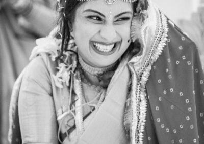 Bride laughing during indian wedding ceremony at Heythrop Park