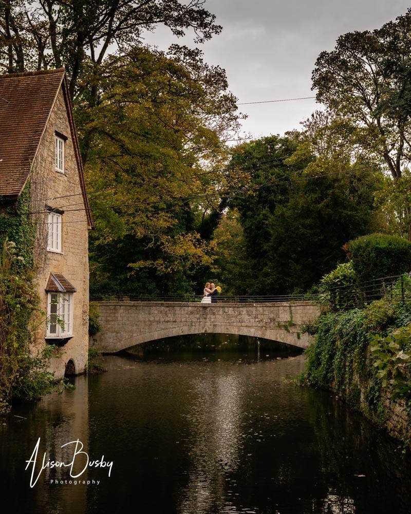 Cosener's House wedding photographer. Bride and groom on bridge.