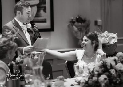 Bride comforting groom during speeches at Milton Hill House wedding Oxfordshire