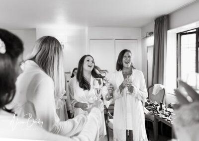 Bridesmaids laughing during bridal prep