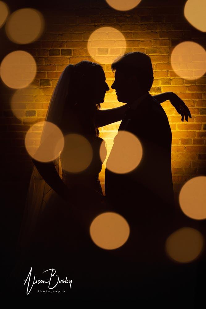 Bride and groom silhouette  by Dovecote Events Wedding Photographer