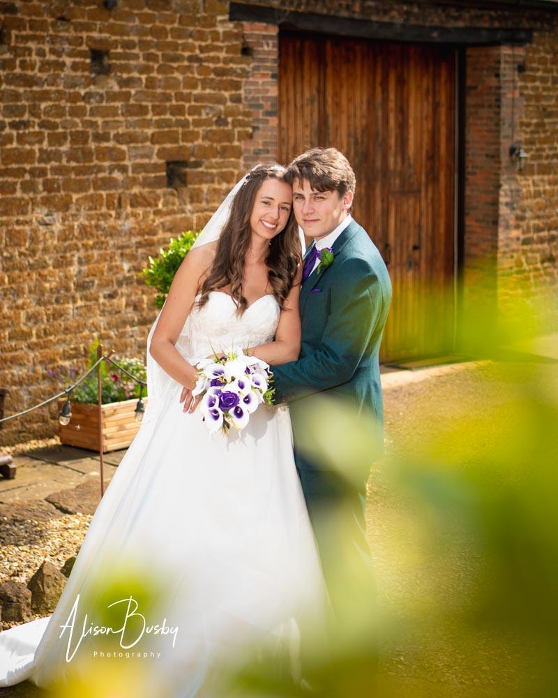 Bride and groom in grounds by Dovecote Events Wedding Photographer