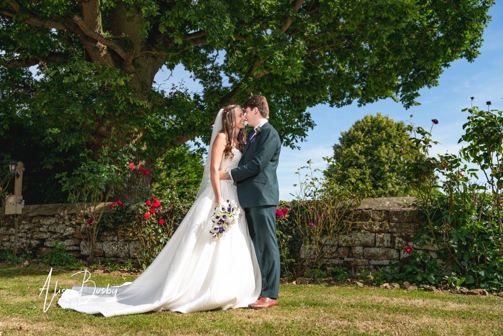 Bride and groom in grounds by Dovecote Events Wedding Photographer