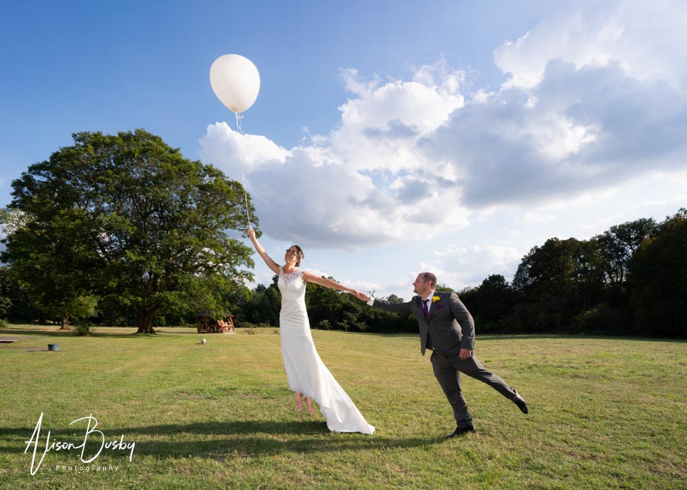 Grovefield House wedding photographer. Bride and groom levitation photo