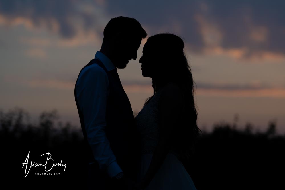Sunset portrait of bride and groom at Kings Chapel Amersham