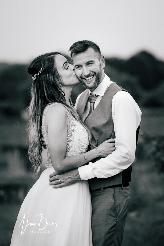 Sunset portrait of bride and groom at Kings Chapel Amersham in black and white