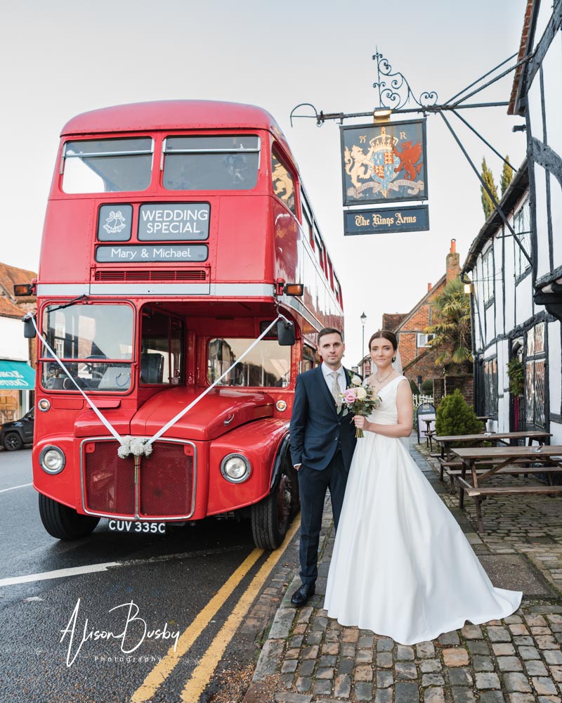 Bride and groom portrait at Kings Chapel in Amersham with red double decker bus