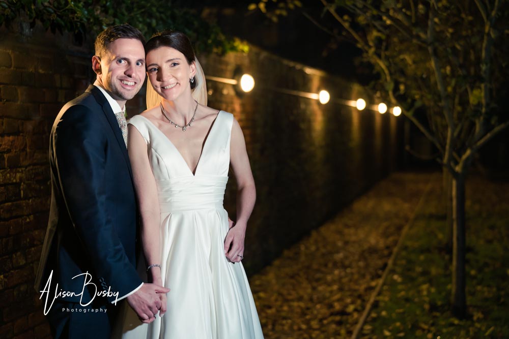 Bride and groom at Kings Chapel wedding at night.