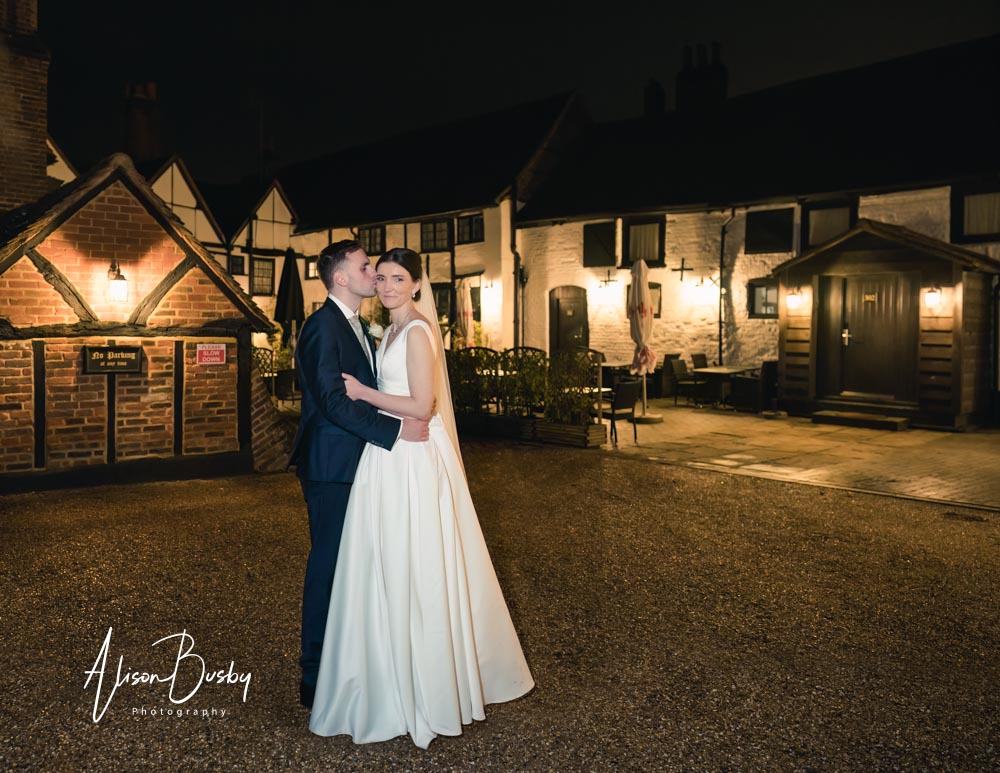Bride and groom at Kings Chapel wedding at night.