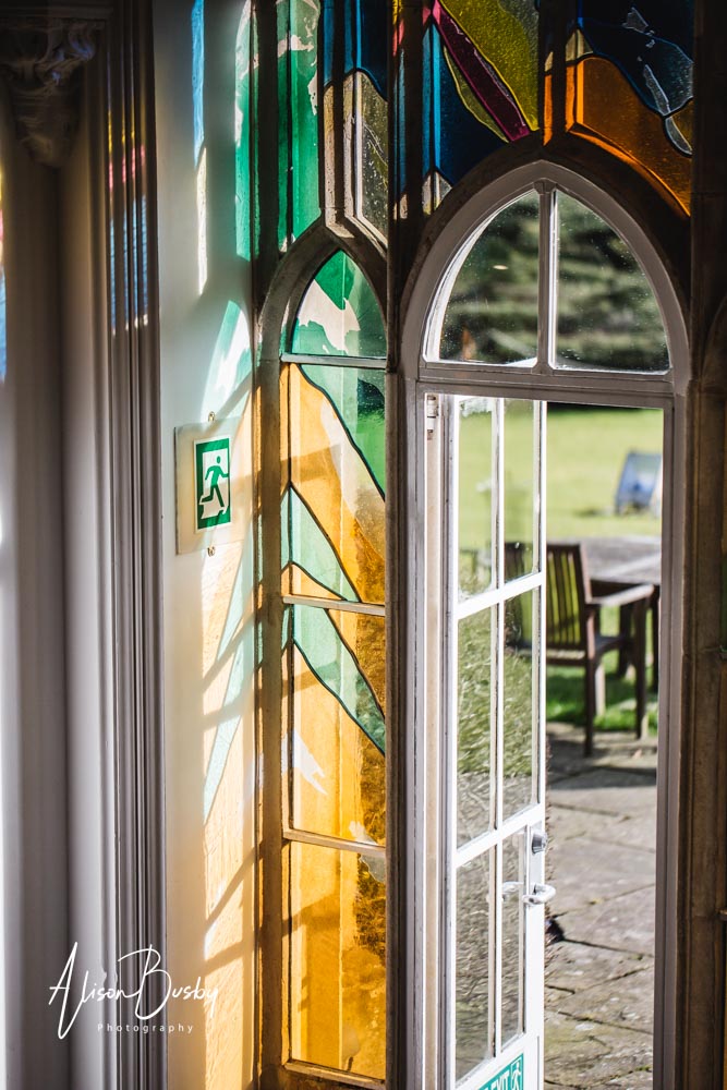 Rainy wedding day. Stained glass exit from Missenden Abbey garden room