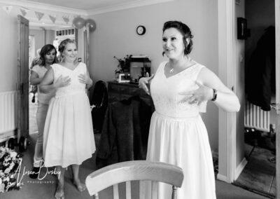 Bridesmaids discussing fitting of Chinese dresses at Buckinghamshire wedding