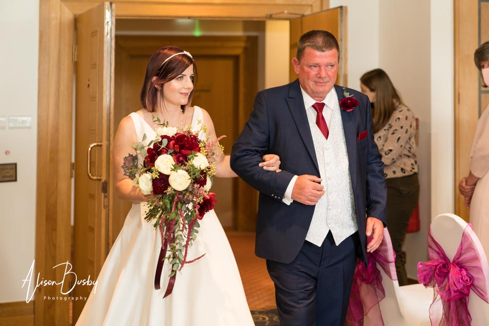 The Oxfordshire wedding photographer. Bride arriving with father to wedding ceremony