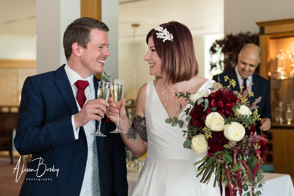 The Oxfordshire wedding photographer. Bride and groom toast each other