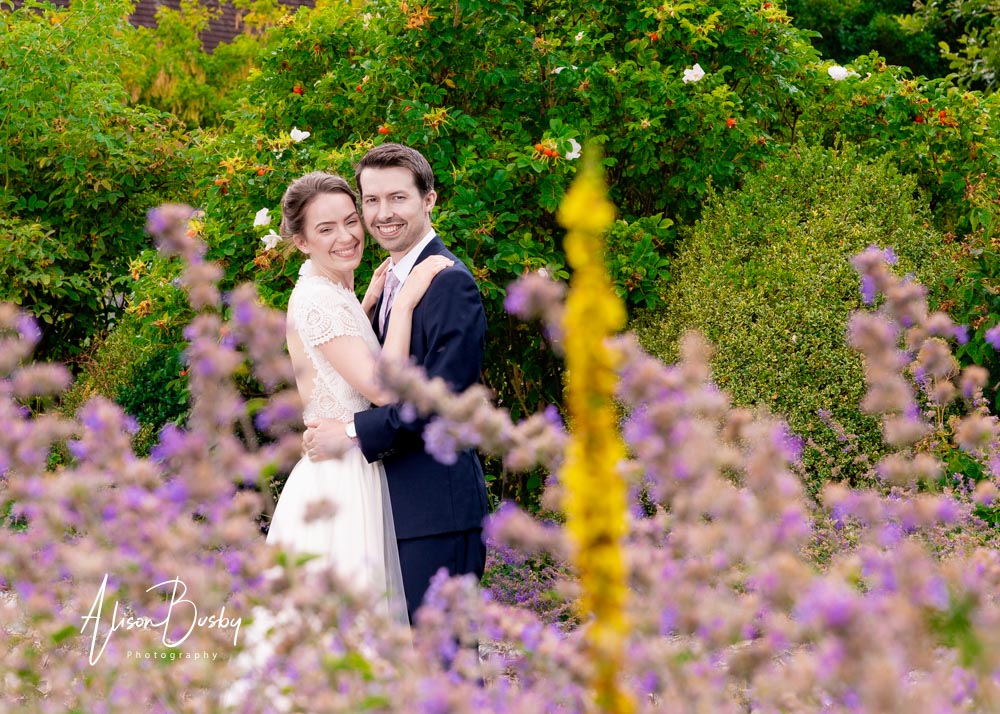 Sheepdrove wedding photographer. Bride and groom in lavender in Physic Garden