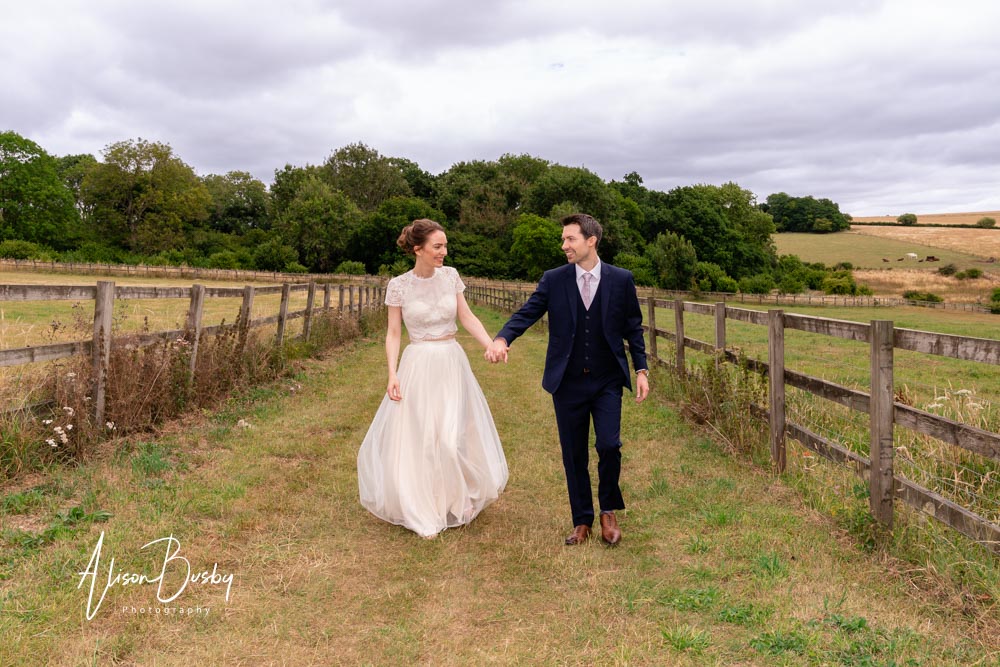 Sheepdrove wedding photographer. Bride and groom walking in grounds