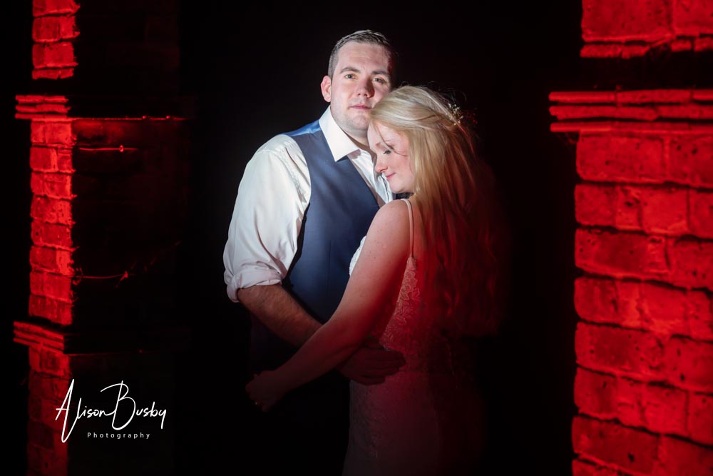 Bride and groom night shot with red gels at Shendish Manor by Alison Busby Photography