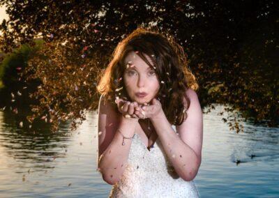 Wedding awards. Bride blowing confetti at Bisham Abbey wedding