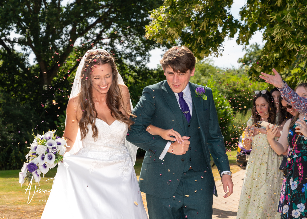 Natural wedding makeup. Bride and groom under confetti