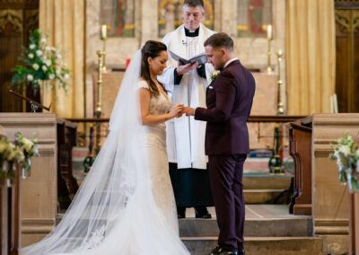 How to choose a wedding photographer in the UK. Bride and groom during ring ceremony.