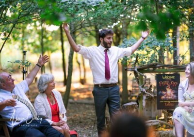 Buckinghamshire woodland wedding. guests around fire pit at Endeavour woodland weddings.