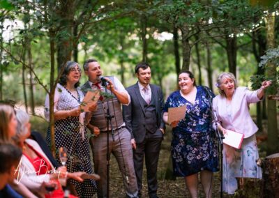 Buckinghamshire woodland wedding. Guests around fire pit at Endeavour woodland weddings.