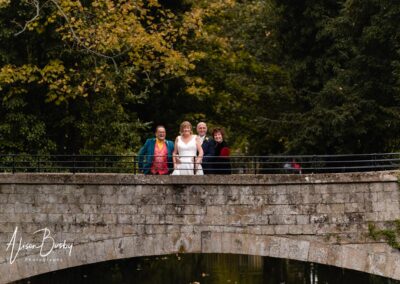 Cosener's House wedding photographer. Bride and groom on bridge with guests