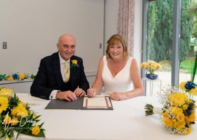 Cosener's House wedding photographer. Bride and groom signing register