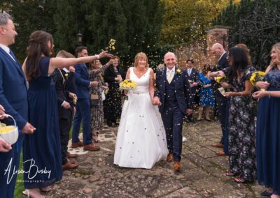 Cosener's House wedding photographer. Bride and groom in confetti tunnel