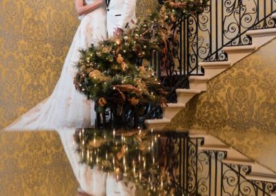 Hedsor House wedding photographer. Couple in on staircase with reflection.