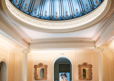 Hedsor House wedding photographer. Couple on balcony of the great hall with glass dome.