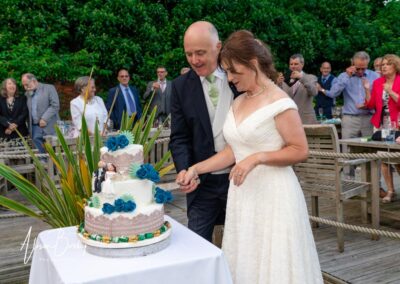 Kings Chapel wedding in September. Bride and groom cutting the cake.