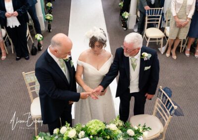 Kings Chapel wedding in September. Father of the bride gives his daughter's hand to the groom