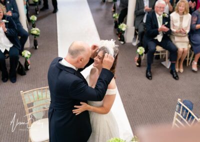 Kings Chapel wedding in September. Bride and groom first kiss.