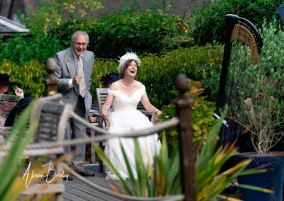 Kings Chapel wedding in September. Bride enjoys a joke with one of her guests in the garden.
