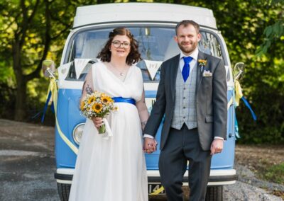 Magnolia Park wedding. Bride and groom in front of blue camper van.