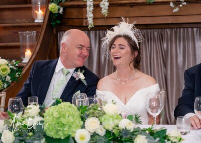 Older Couple wedding photos. Bride and groom laughing during speeches.