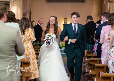 Bride and groom leaving ceremony at Our Lady and St Edmunds Church in Abingdon, Oxfordshire.