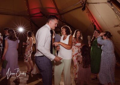Oxfordshire tipi wedding at Dovecote Events. Guests dancing.