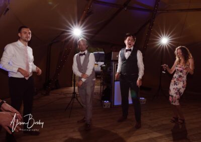 Oxfordshire tipi wedding at Dovecote Events. Guests dancing.