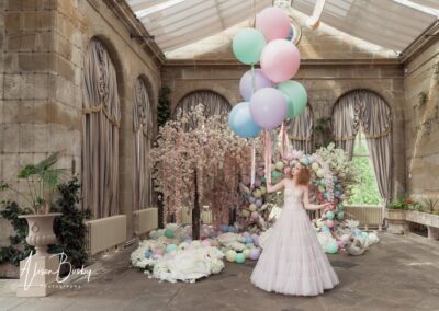 Planning a wedding. Bride with pink blossoms and pastel coloured balloons.